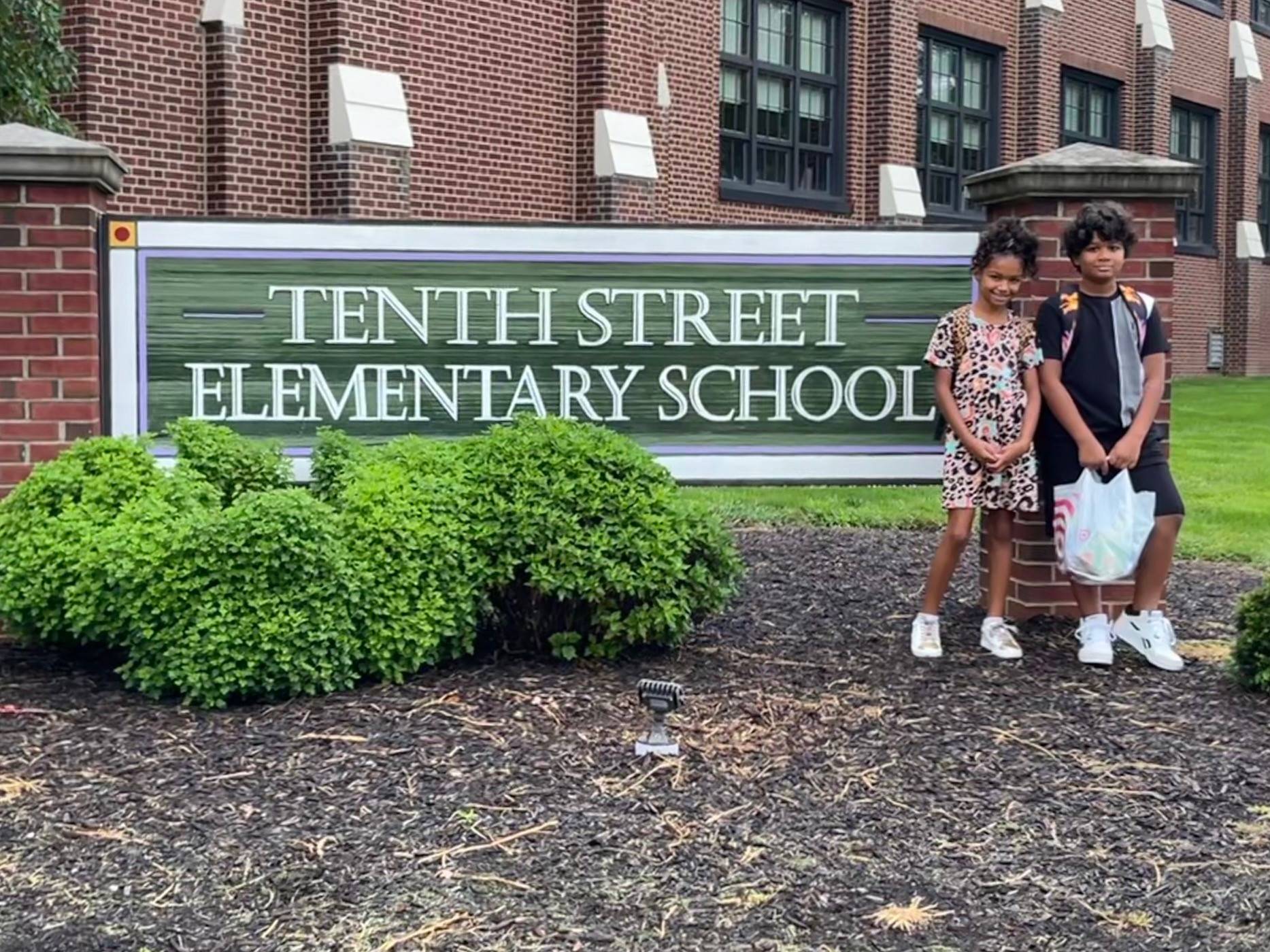 Tenth Street Sign. Students pose for a photo.